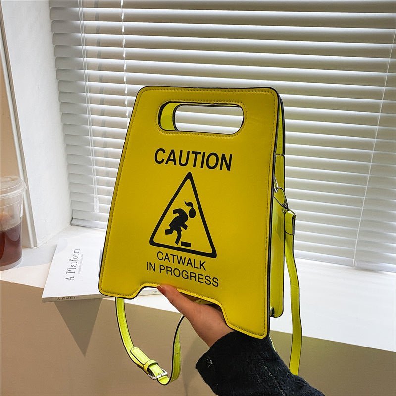 women yellow shoulder bag caution